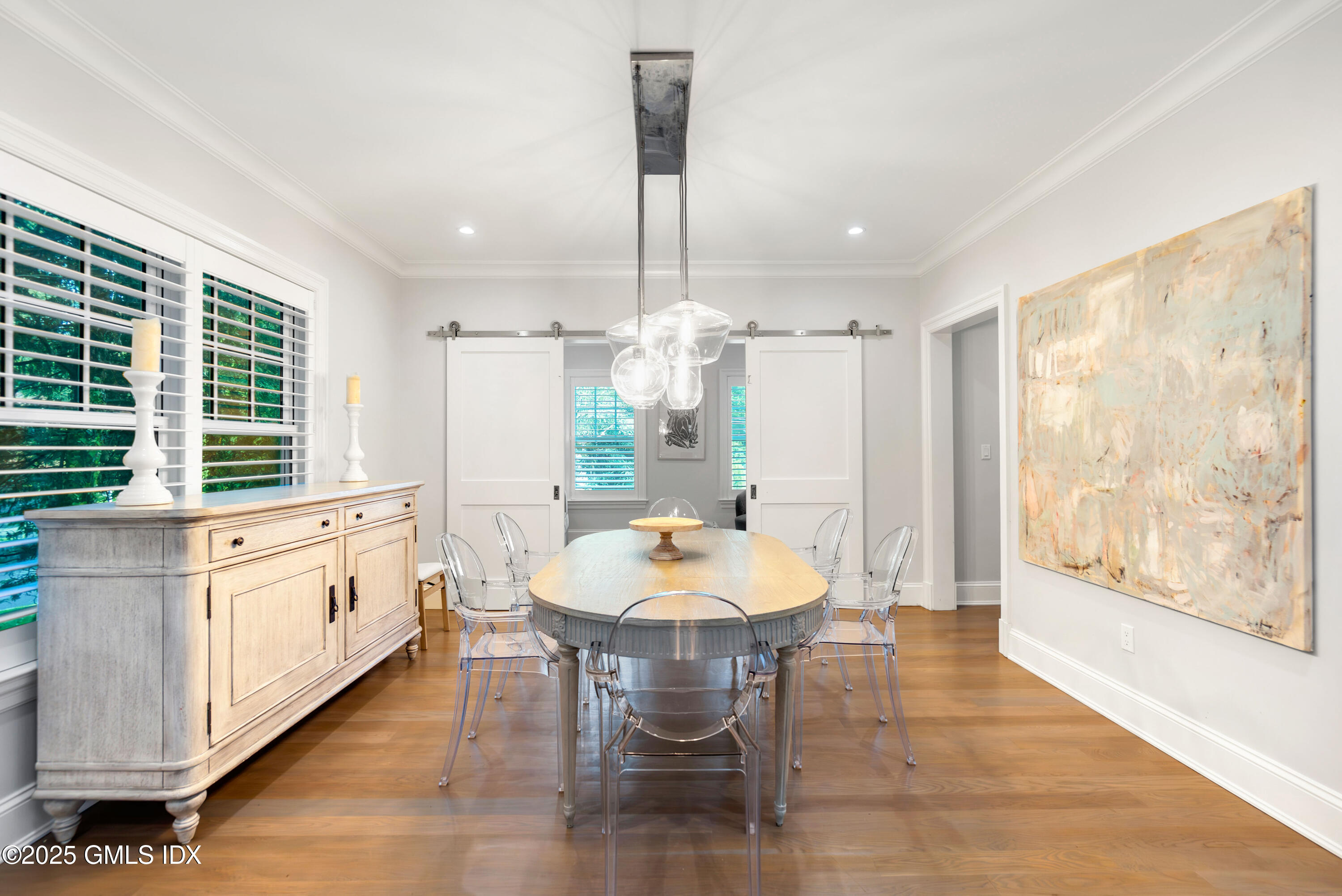 53 Long Meadow Road Riverside, CT 06878 - Photo 9 of 27 a dining room with chandelier and wooden floor
