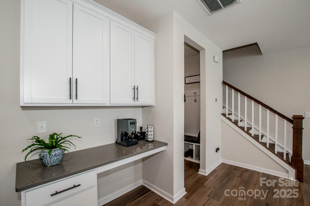 1270 Brawley School Road, Unit F Mooresville, NC 28117 - Photo 18 of 47 a kitchen with white cabinets and potted plant