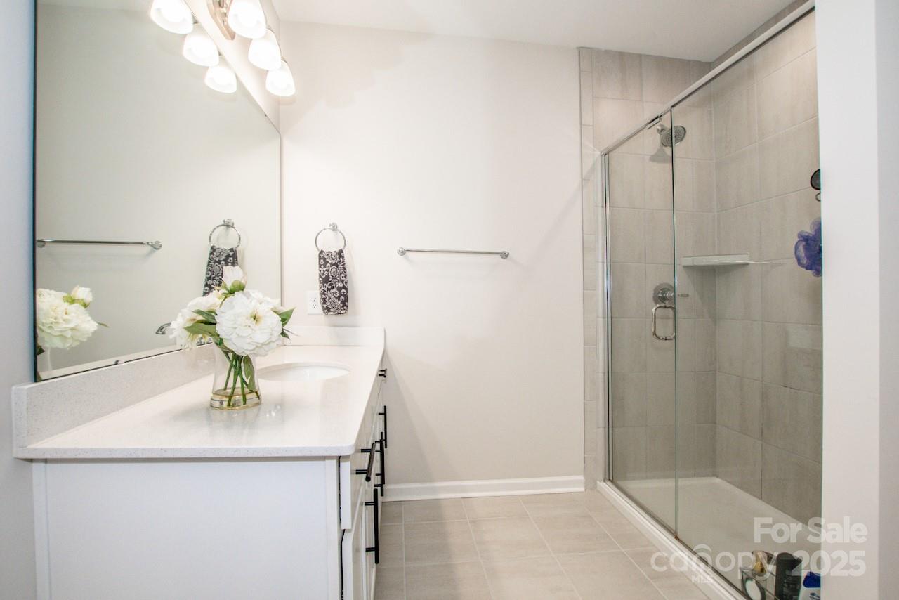 1270 Brawley School Road, Unit F Mooresville, NC 28117 - Photo 31 of 47 a bathroom with a sink a mirror and shower