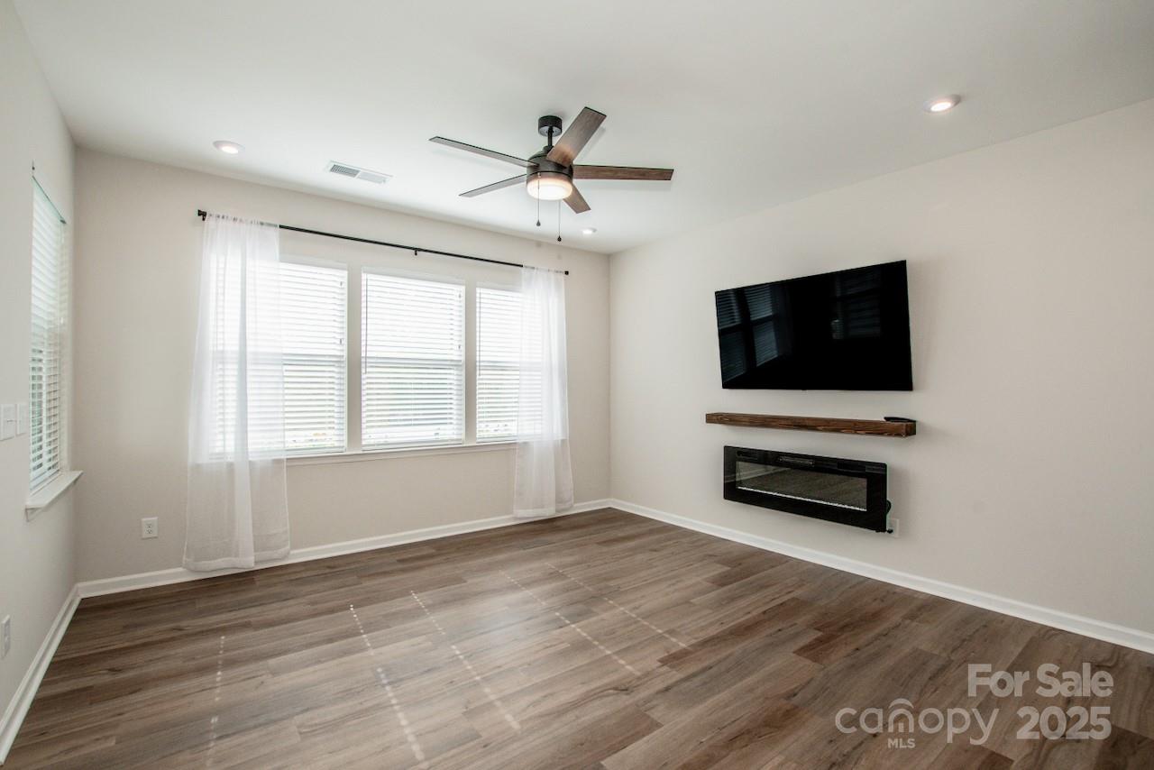 1270 Brawley School Road, Unit F Mooresville, NC 28117 - Photo 7 of 47 a living room with hardwood floor and flat screen tv