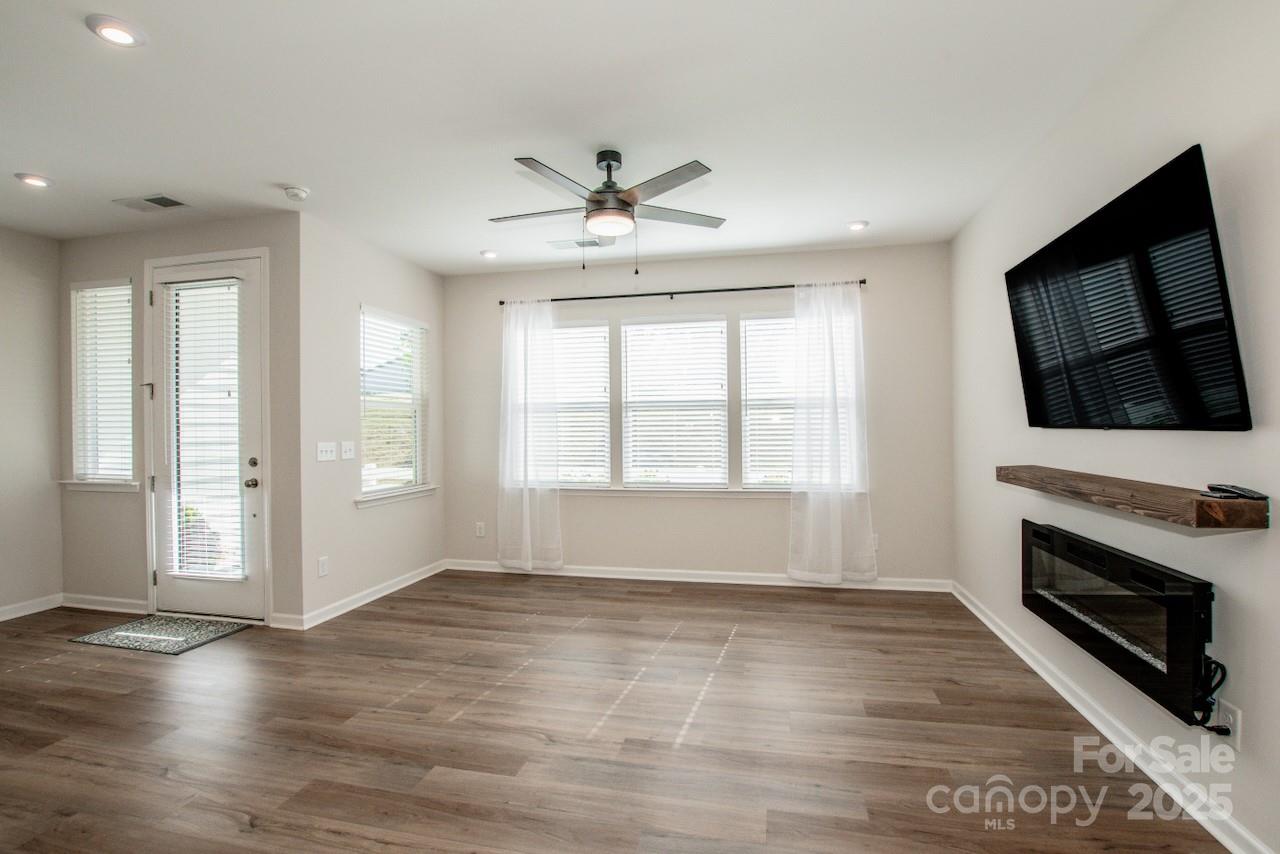 1270 Brawley School Road, Unit F Mooresville, NC 28117 - Photo 8 of 47 a view of an empty room with a fireplace and a window