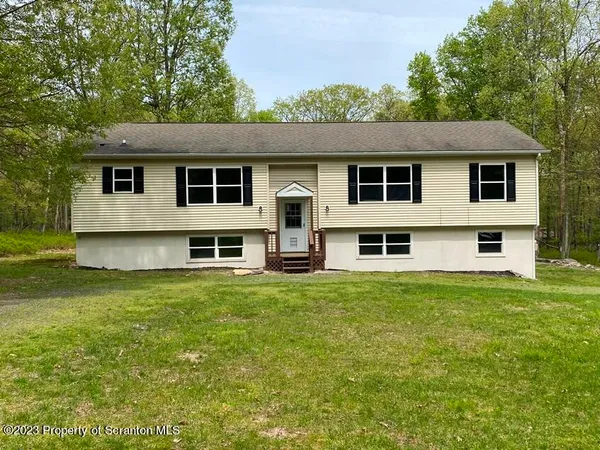 a house that has a big yard with wooden fence