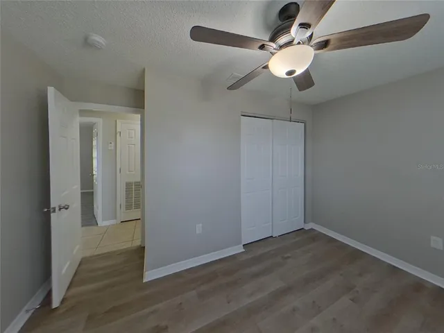a bathroom with a granite countertop sink a toilet and mirror