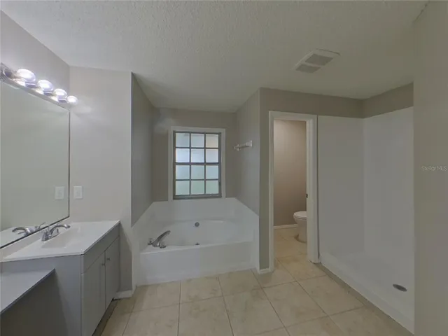a bathroom with a bathtub and shower