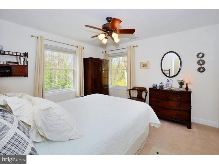 658 Knox Road Wayne, PA 19087 - Photo 15 of 25 a bedroom with a bed mirror and a window