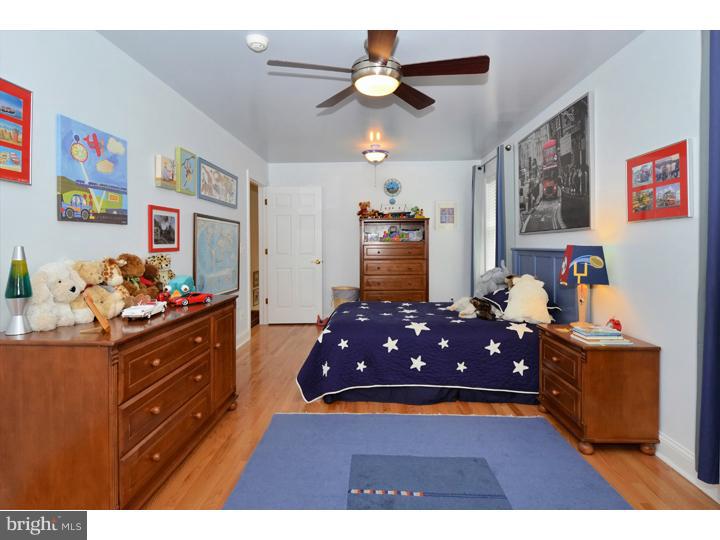 658 Knox Road Wayne, PA 19087 - Photo 16 of 25 a bedroom with a bed and a chandelier