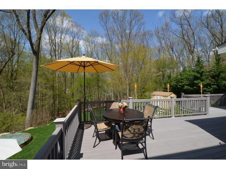 658 Knox Road Wayne, PA 19087 - Photo 21 of 25 a view of a patio with a table and chairs under an umbrella