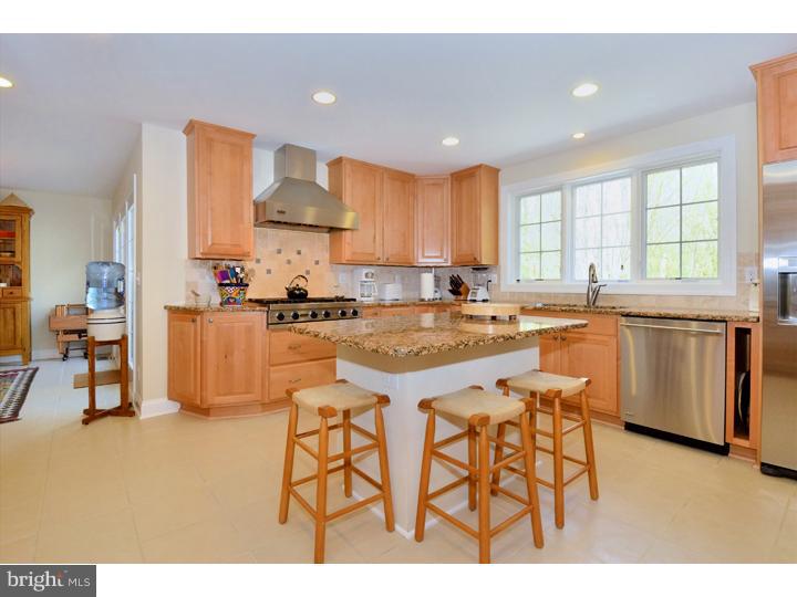 658 Knox Road Wayne, PA 19087 - Photo 6 of 25 a kitchen with stainless steel appliances a table and chairs in it