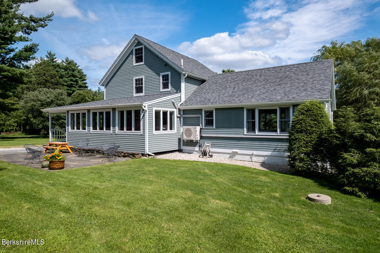 319 Hancock Road Williamstown, MA 01267 - Photo 5 of 39 a front view of a house with a yard table and chairs