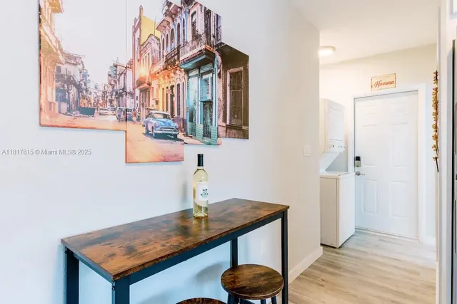 a kitchen with a sink and a wooden floor