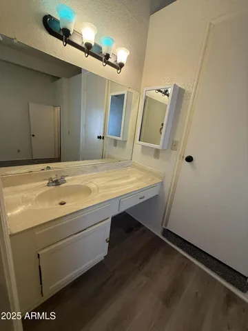 a bathroom with a sink a mirror and vanity