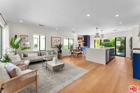 a living room with fireplace furniture and a wooden floor
