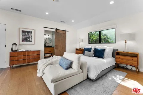 a spacious bedroom with a bed and a couch