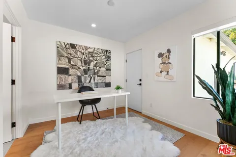 a view of work space with furniture and window