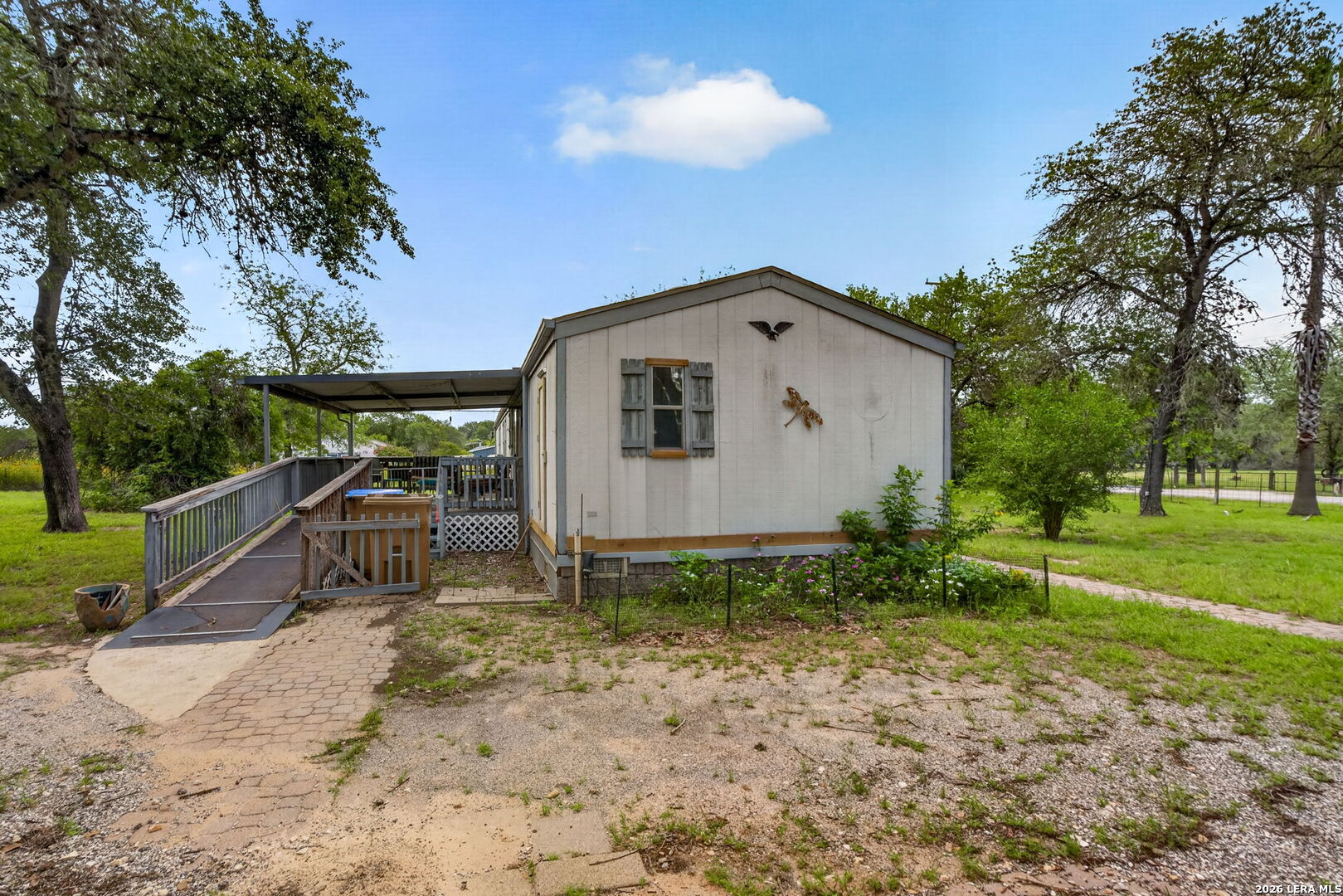 23398 Mathis Road Elmendorf, TX 78112 - Photo 18 of 18 a front view of a house with garden