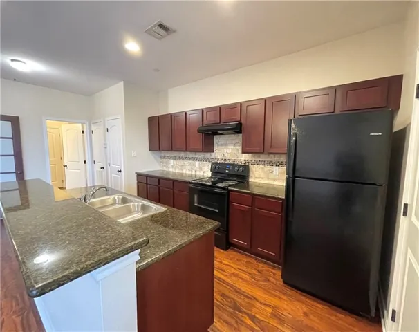 a view of a kitchen with a sink and cabinets