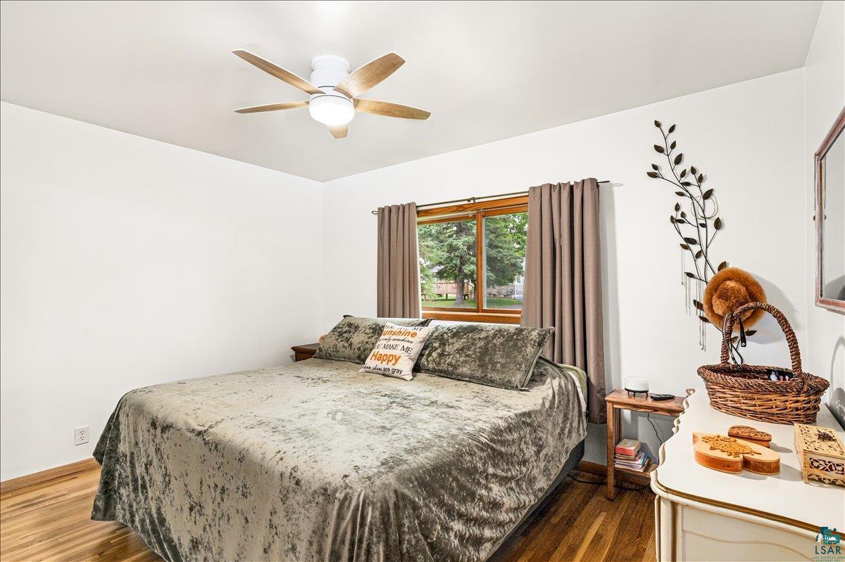 130 West Austin Street Duluth, MN 55803 - Photo 11 of 35 Room featuring hardwood flooring, a ceiling fan with integrated lighting, and a window with wood trim