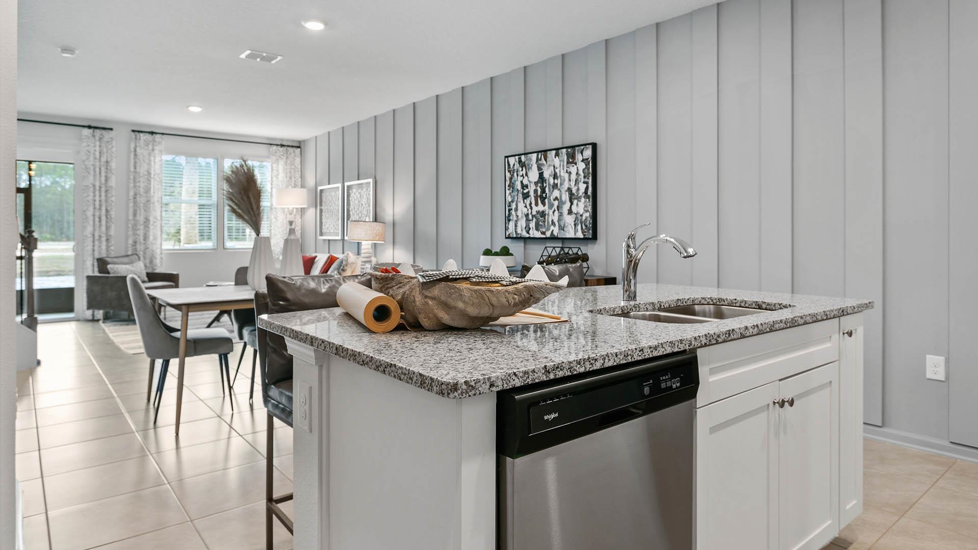 293 Redbud Road Palm Coast, FL 32137 - Photo 8 of 33 a kitchen with stainless steel appliances granite countertop a sink counter space and a table