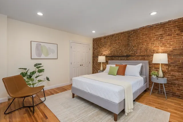 a bedroom with a bed and chair