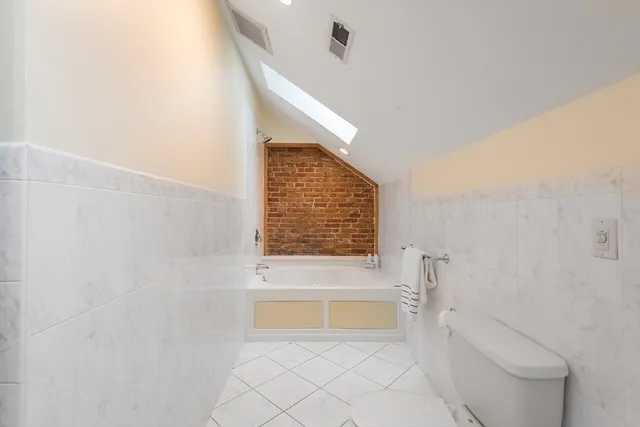 a bathroom with a bathtub and a toilet