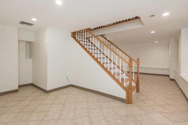 a view of entryway and hall with a front door