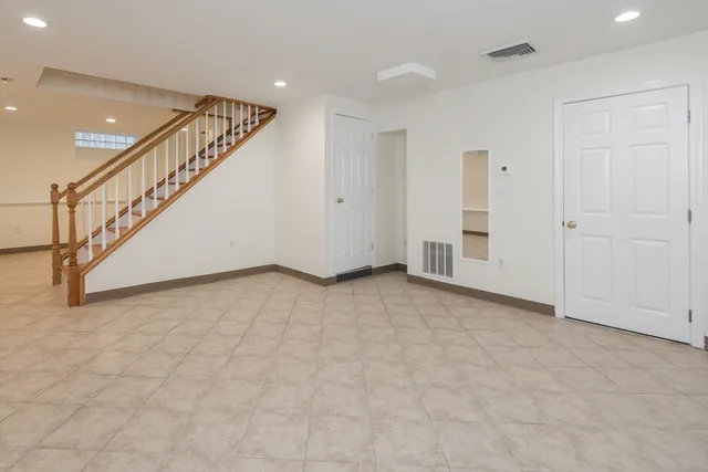 a view of an empty room with stairs