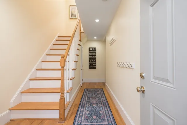 a view of a hallway with wooden floor and entryway