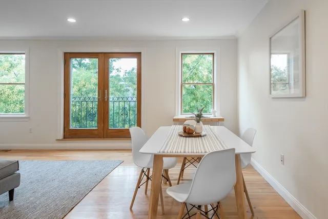 a view of a dining room with furniture window and wooden floor