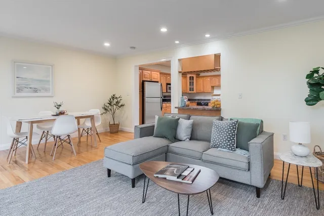 a living room with furniture kitchen view and a dining table
