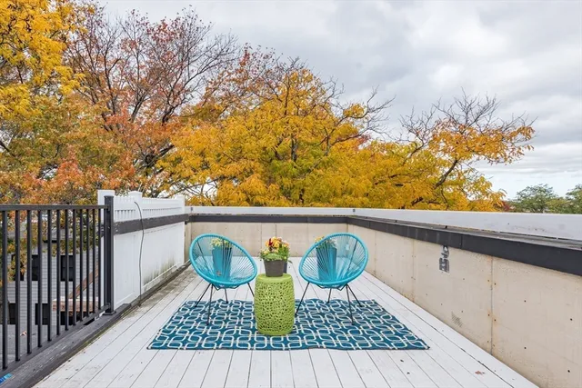 a view of a patio with table and chairs and wooden floor