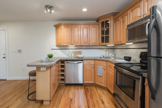 a kitchen with a sink stove and cabinets