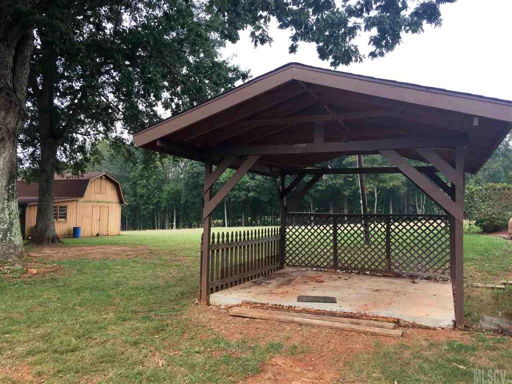 2187 Startown Road Newton, NC 28658 - Photo 11 of 21 a view of backyard with small cabin and wooden fence