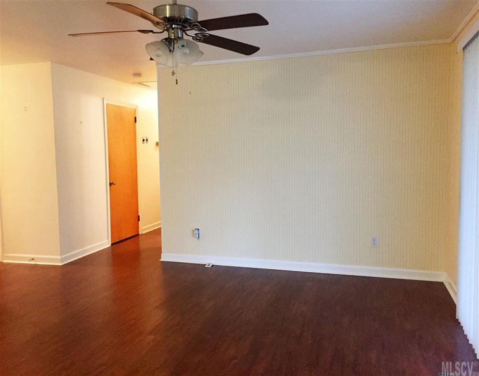 2187 Startown Road Newton, NC 28658 - Photo 17 of 21 an empty room with wooden floor and a ceiling fan