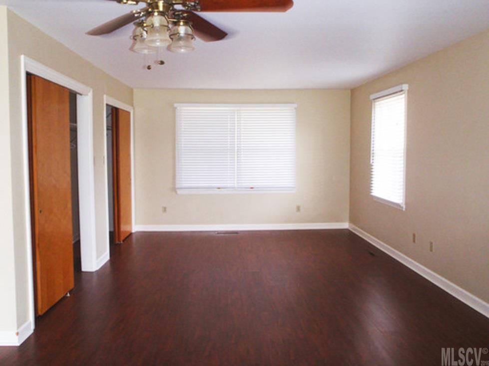 2187 Startown Road Newton, NC 28658 - Photo 3 of 21 a view of an empty room with wooden floor and a window