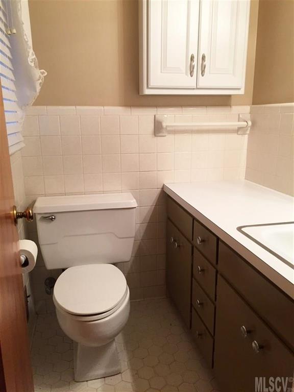 2187 Startown Road Newton, NC 28658 - Photo 4 of 21 a bathroom with a toilet a sink and mirror