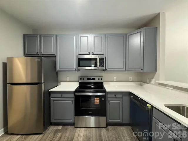 a kitchen with a refrigerator sink and microwave