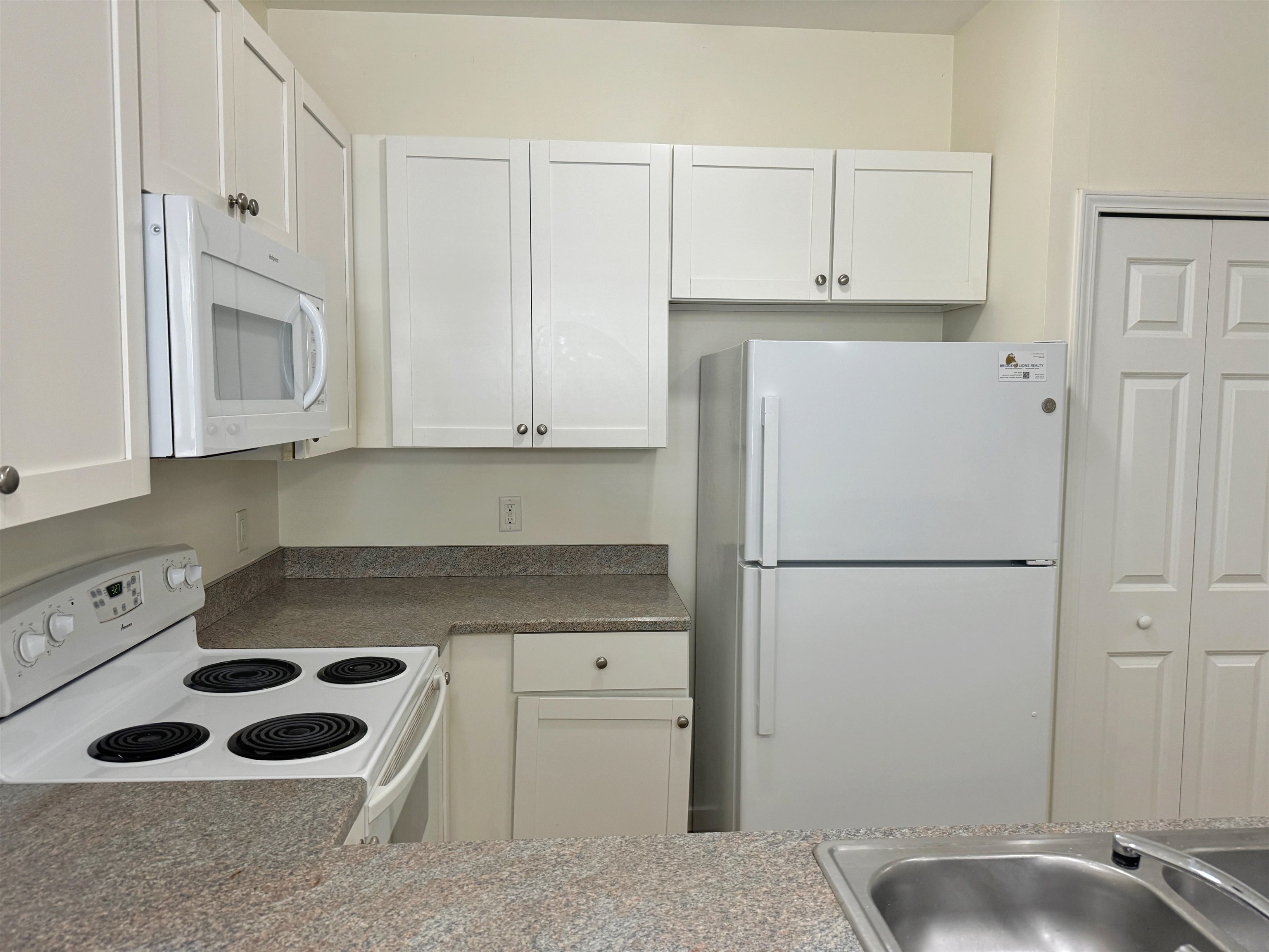 38 Weeden Street, Unit A St. Augustine, FL 32084 - Photo 11 of 29 a kitchen with a refrigerator sink and cabinets