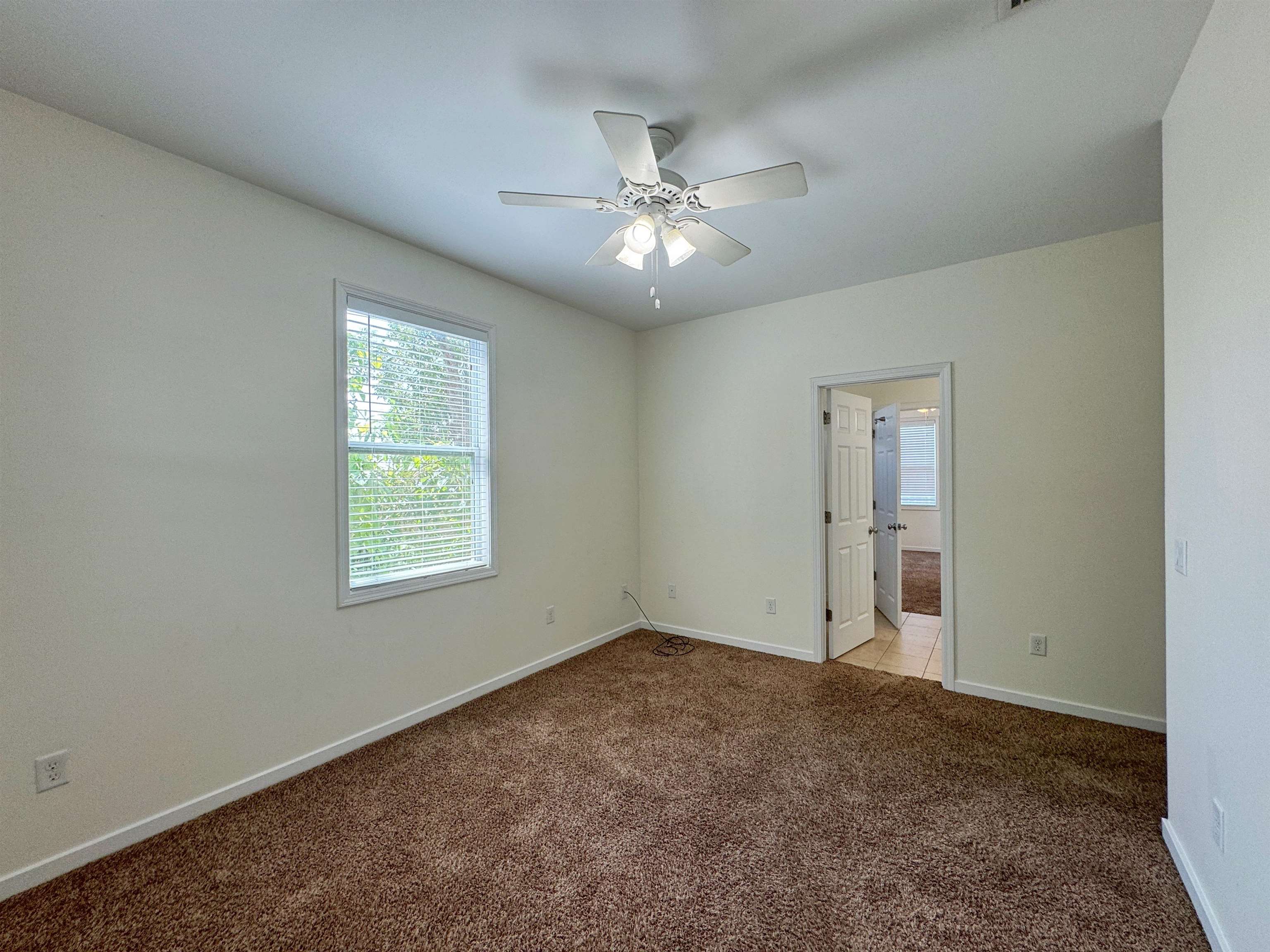38 Weeden Street, Unit A St. Augustine, FL 32084 - Photo 17 of 29 an empty room with windows and fan