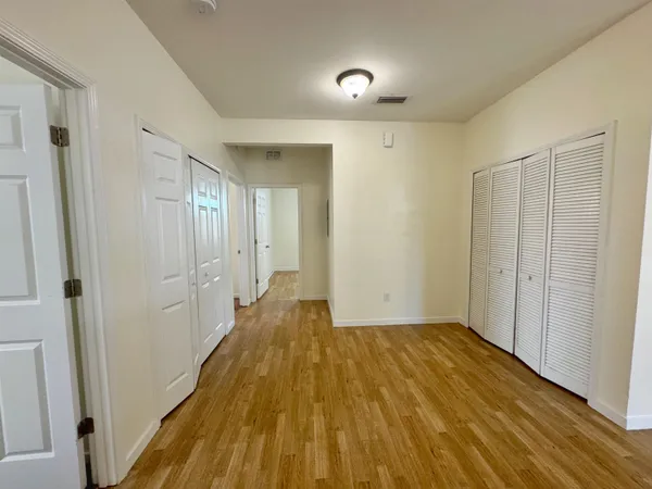 a view of a room with wooden floor and a bathroom