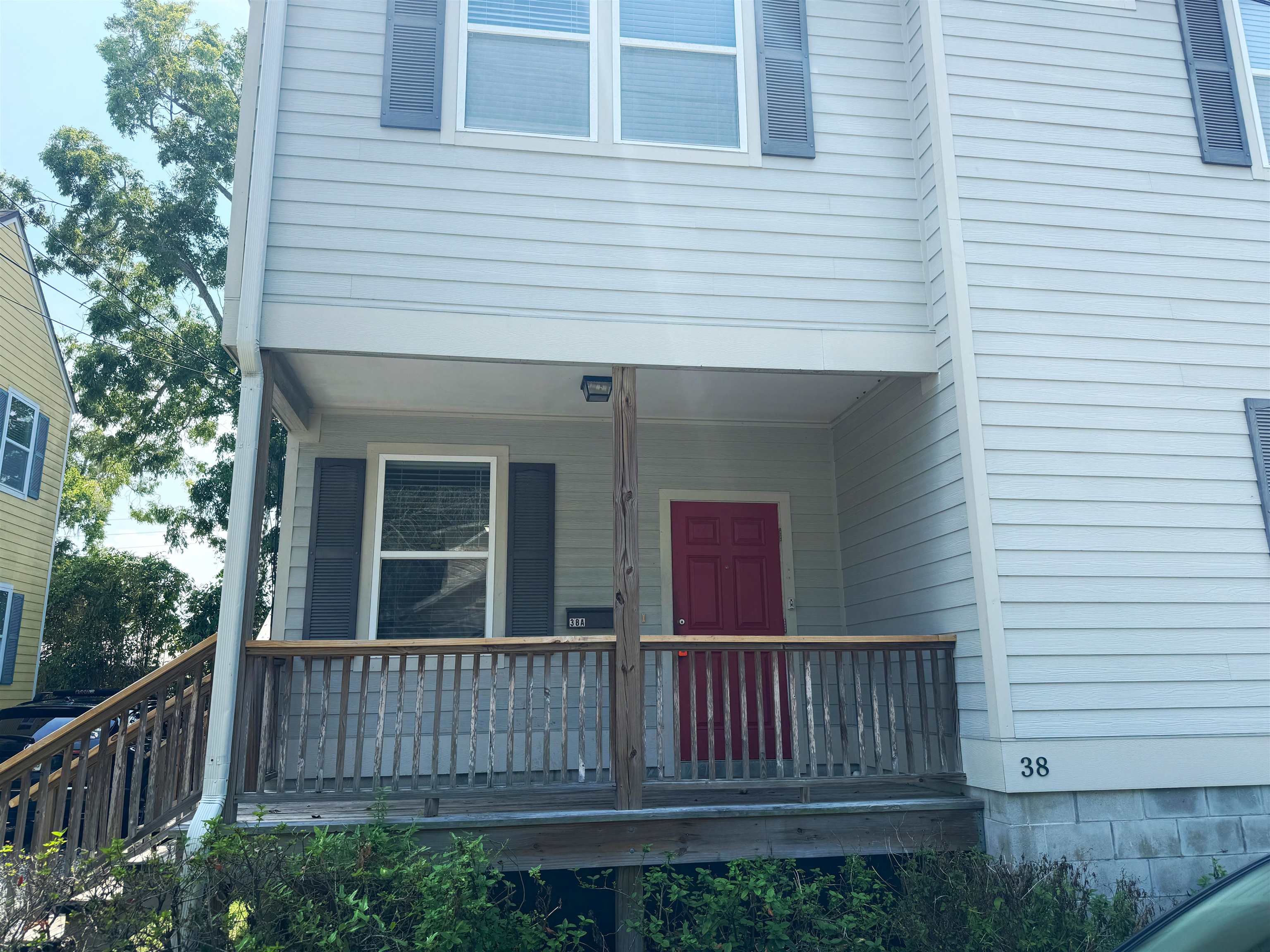 38 Weeden Street, Unit A St. Augustine, FL 32084 - Photo 2 of 29 a view of a house with a small yard and wooden fence