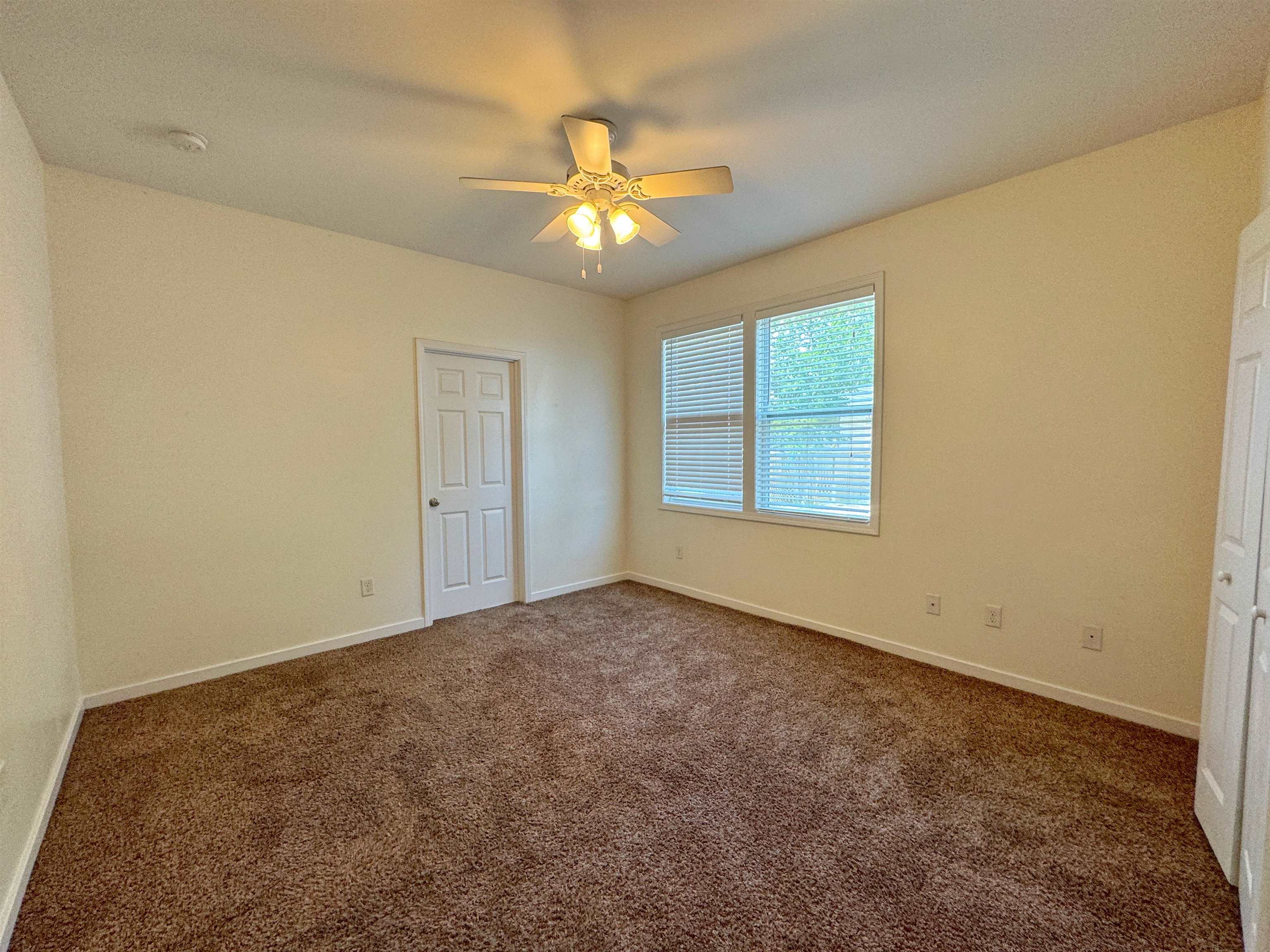 38 Weeden Street, Unit A St. Augustine, FL 32084 - Photo 22 of 29 an empty room with windows and chandelier fan