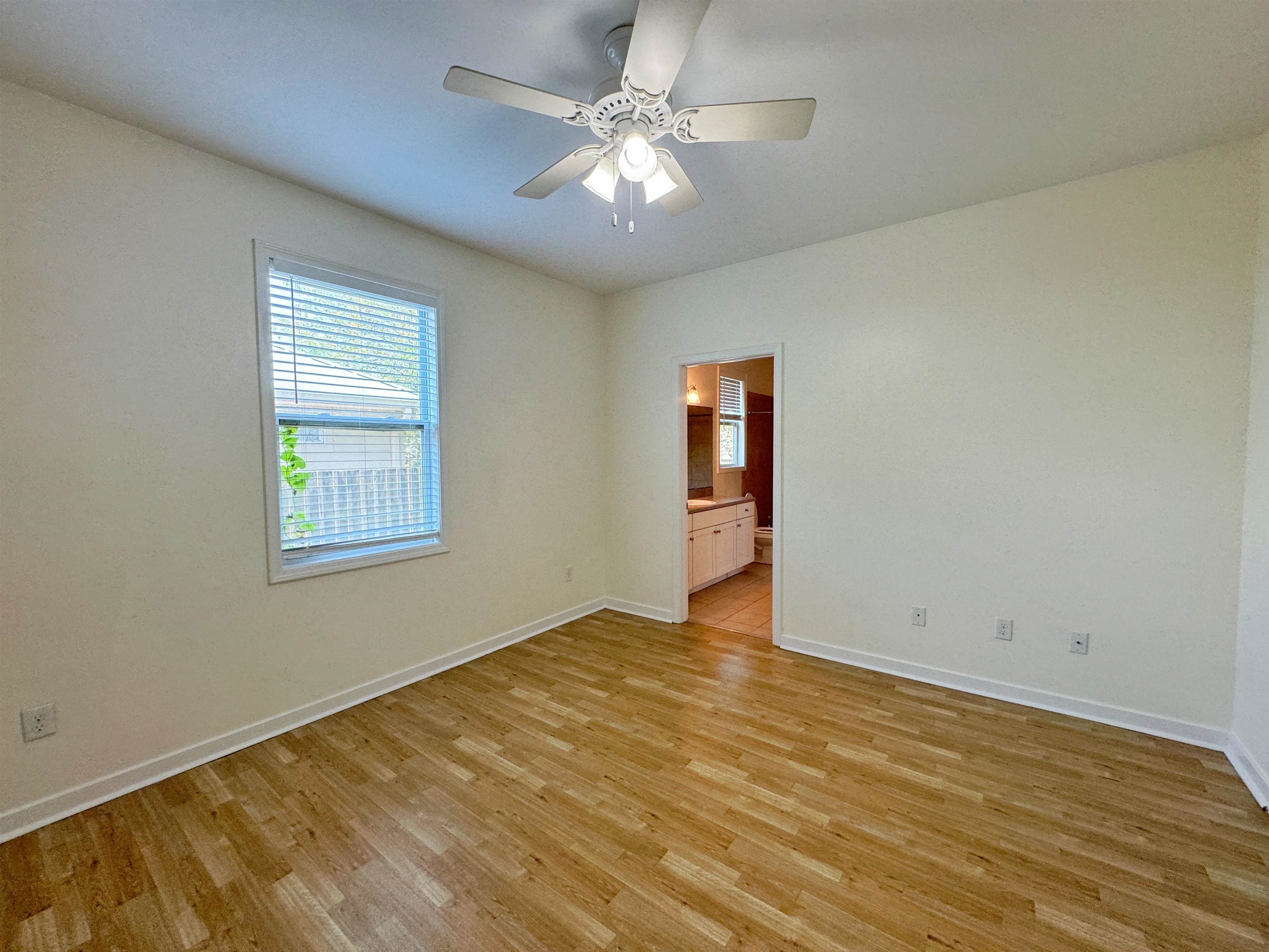 38 Weeden Street, Unit A St. Augustine, FL 32084 - Photo 26 of 29 an empty room with windows and ceiling fan