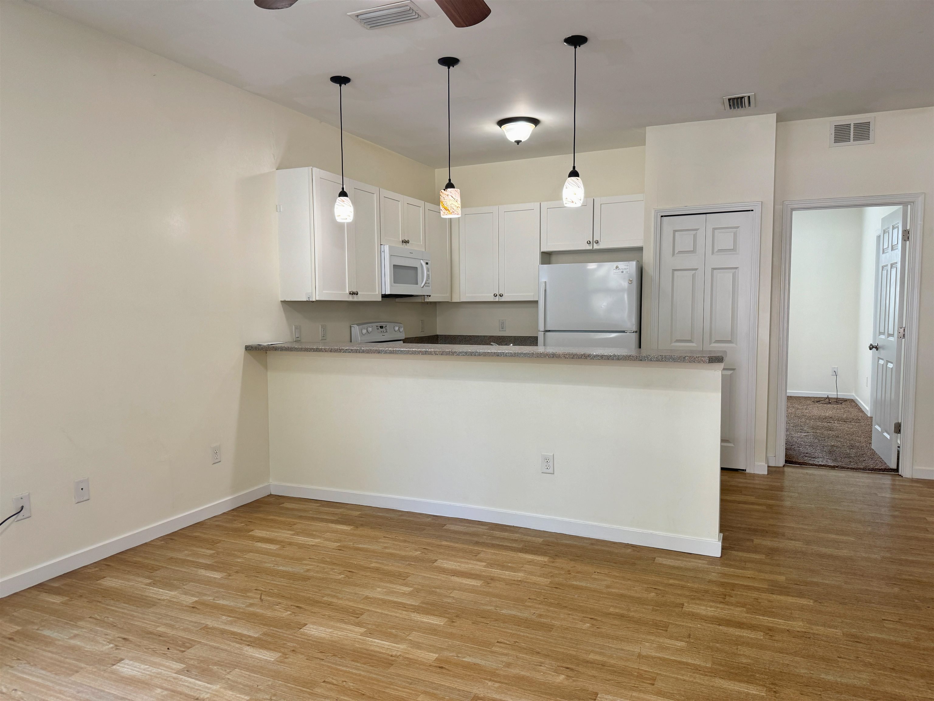 38 Weeden Street, Unit A St. Augustine, FL 32084 - Photo 4 of 29 a view of a kitchen with stainless steel appliances granite countertop white cabinets and a granite counter tops