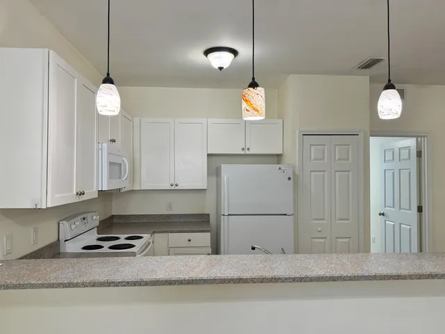 a kitchen with cabinets and window
