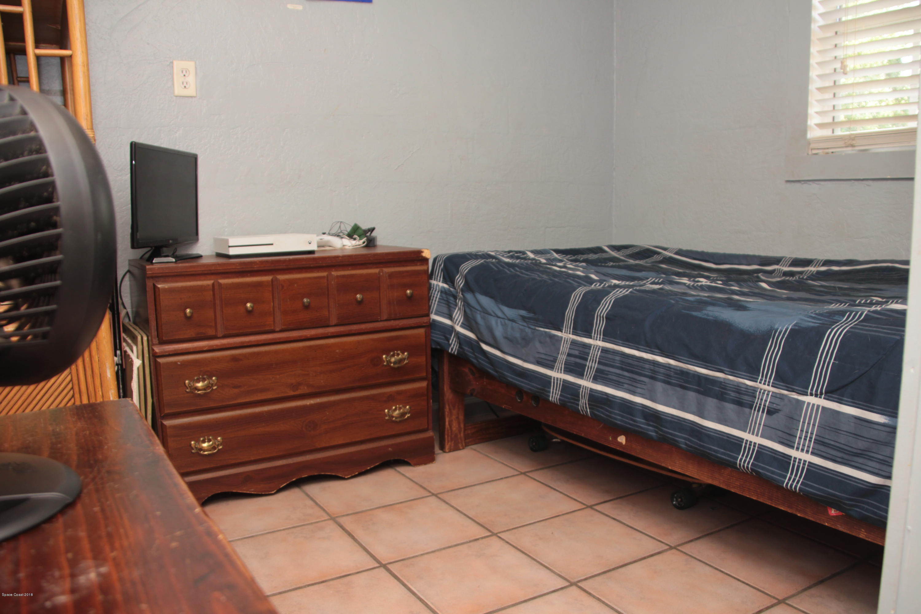 5308 Riveredge Drive Titusville, FL 32780 - Photo 11 of 25 a room with a bed and a mirror
