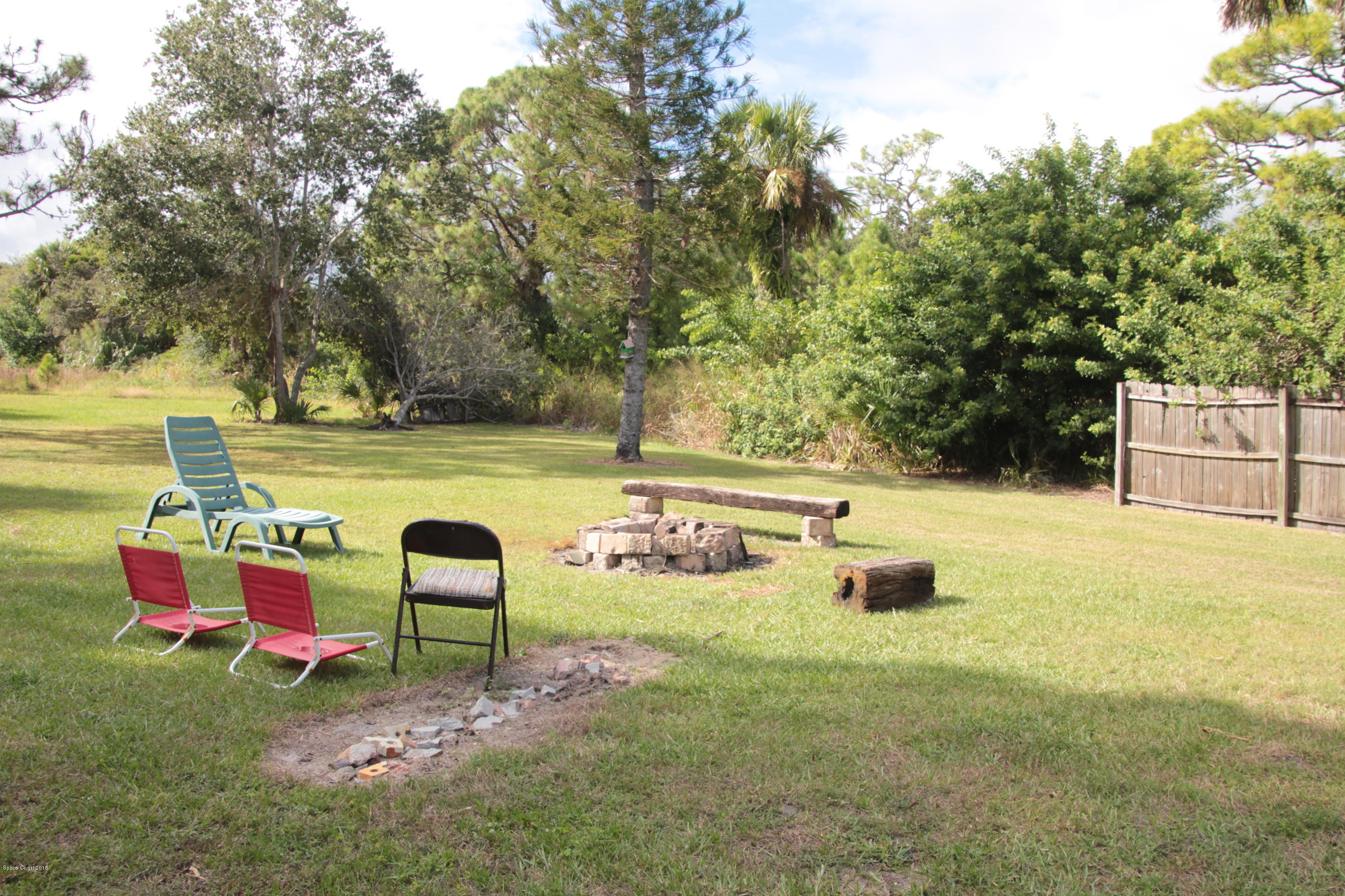 5308 Riveredge Drive Titusville, FL 32780 - Photo 22 of 25 a park view with a bench and trees around