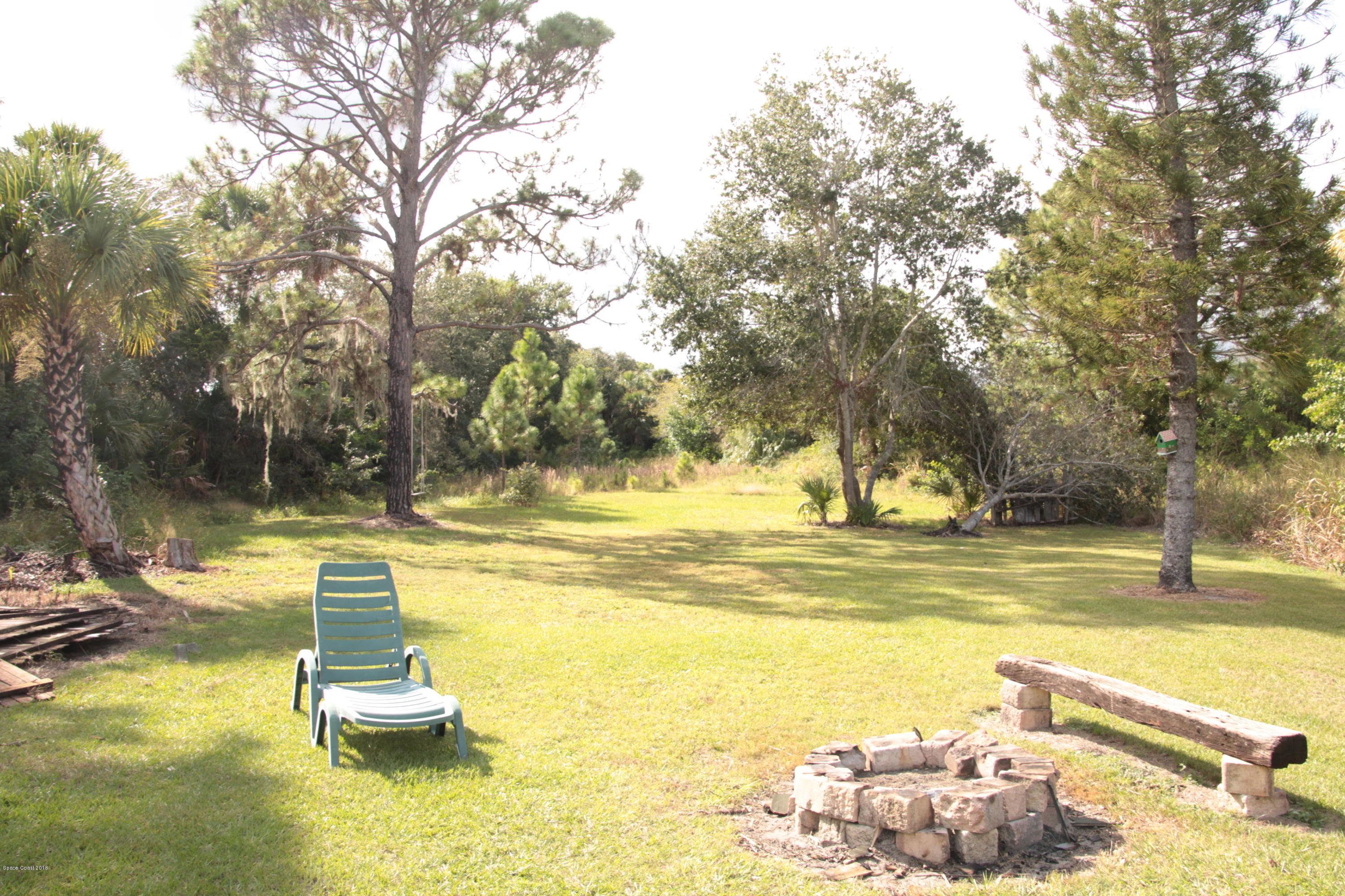 5308 Riveredge Drive Titusville, FL 32780 - Photo 24 of 25 a view of a swimming pool with a patio and a yard with lake view