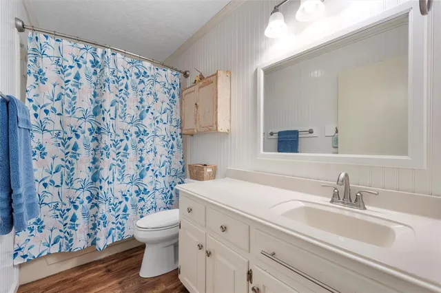 a bathroom with a sink toilet and shower