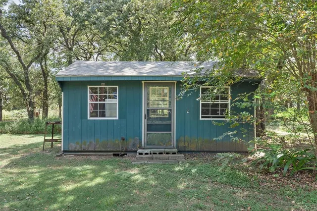 a view of a patio with table and chairs
