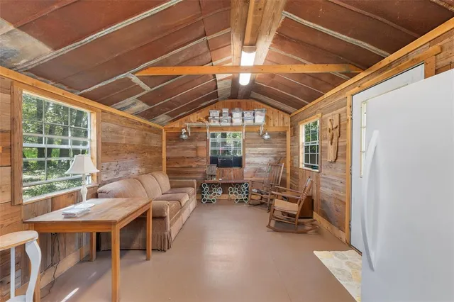 a view of a house with backyard porch and sitting area